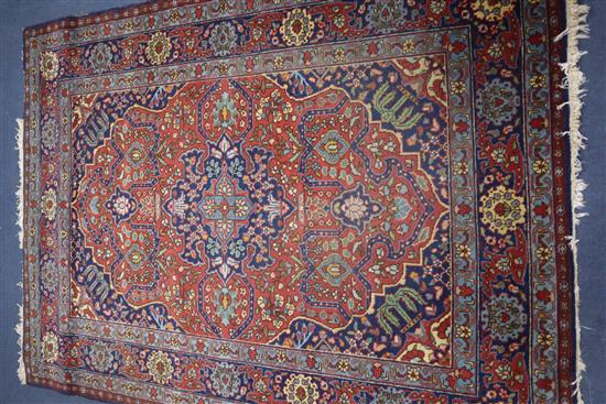 A Heriz style brick red ground rug 190 x 139cm